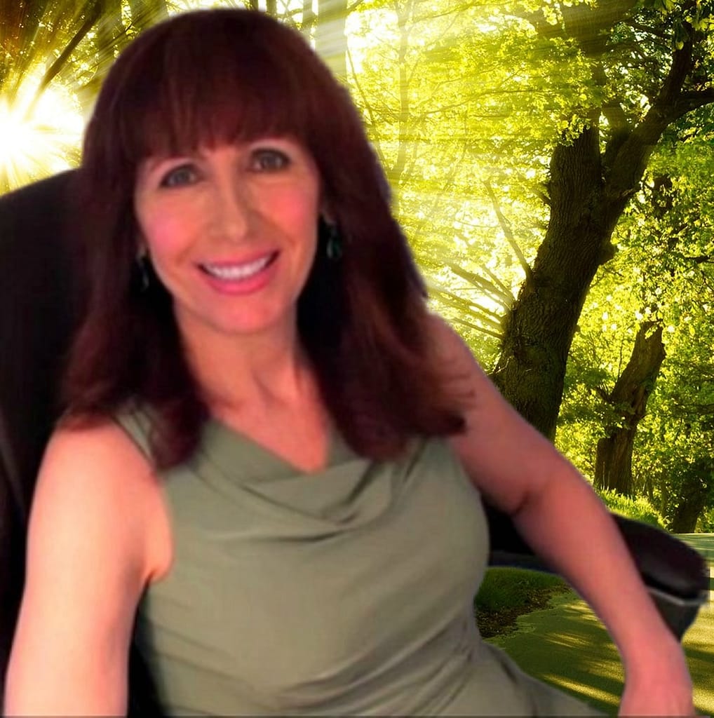 Smiling woman seated in chair by sunlit forest