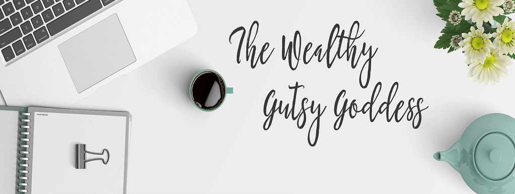 The Wealthy Gutsy Goddess header flat lay
