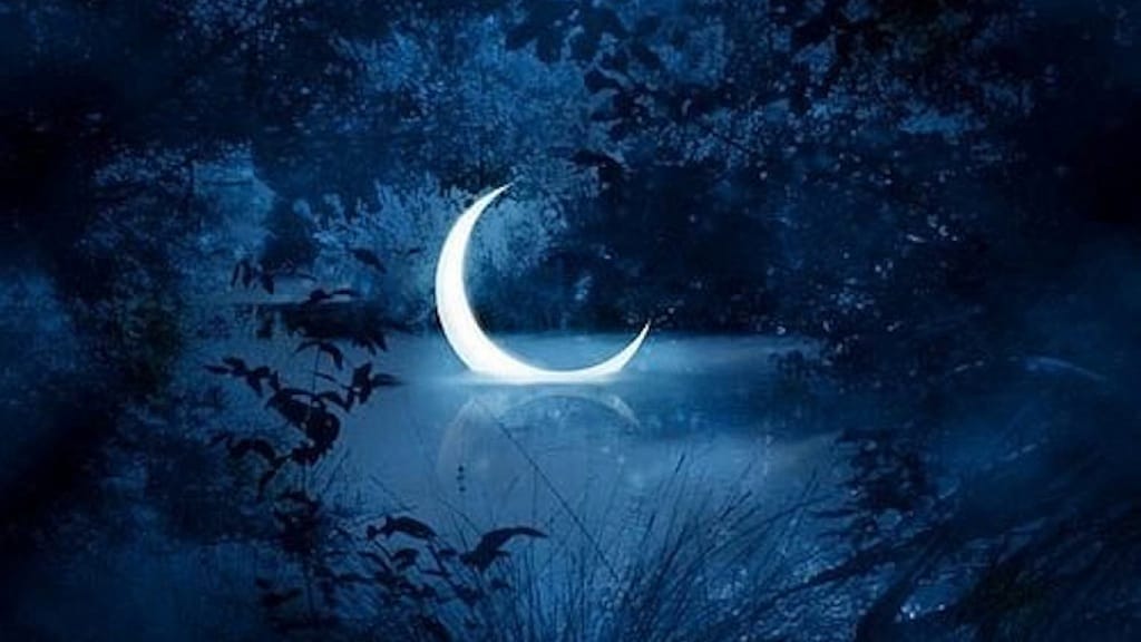 Glowing crescent moon boat on reflective water