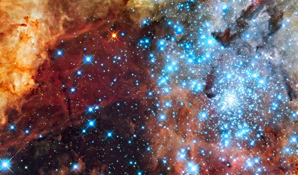 Colorful nebula with bright blue star cluster