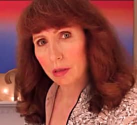 Portrait of woman with auburn hair, sequined jacket