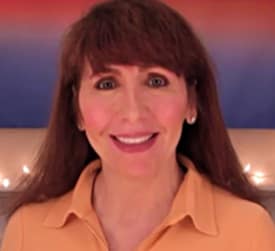 Smiling woman headshot with warm background lights
