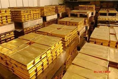 Stacks of gold bars in storage vault