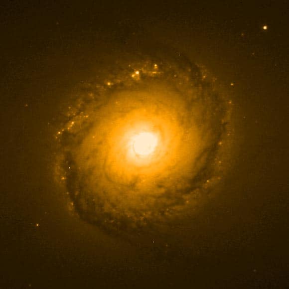 Golden spiral galaxy with bright glowing core